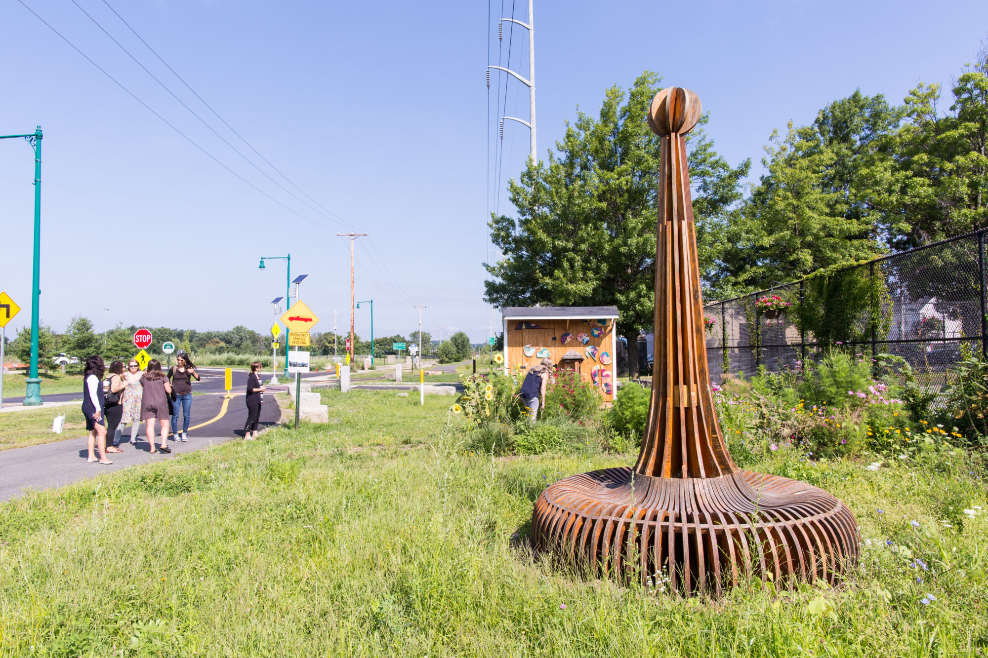 A grassy community space shown on a bright, summer day.