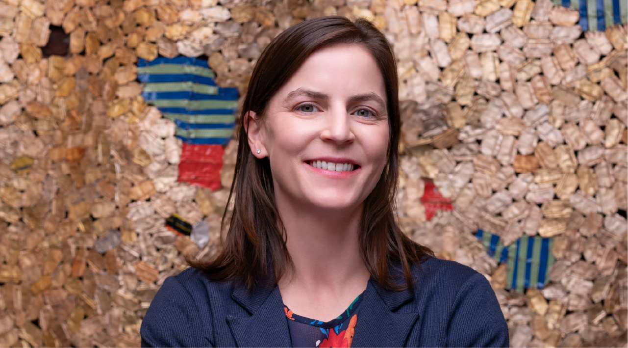 Mary Chalifour poses for a headshot. She has brown hair and smiles warmly.