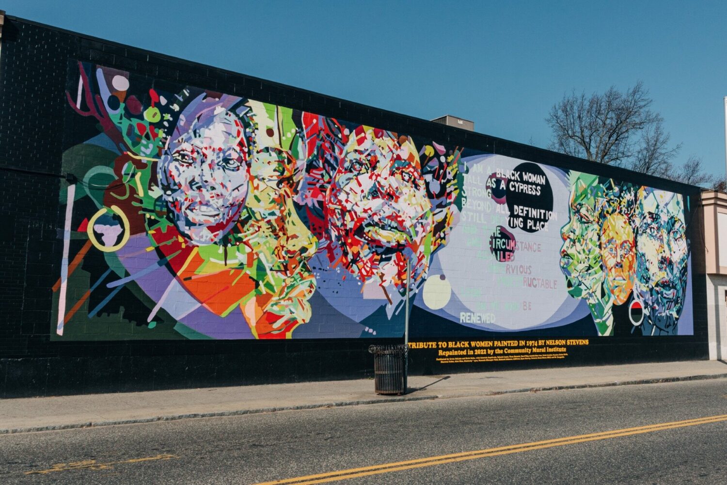 A large mural features prominent Black women.