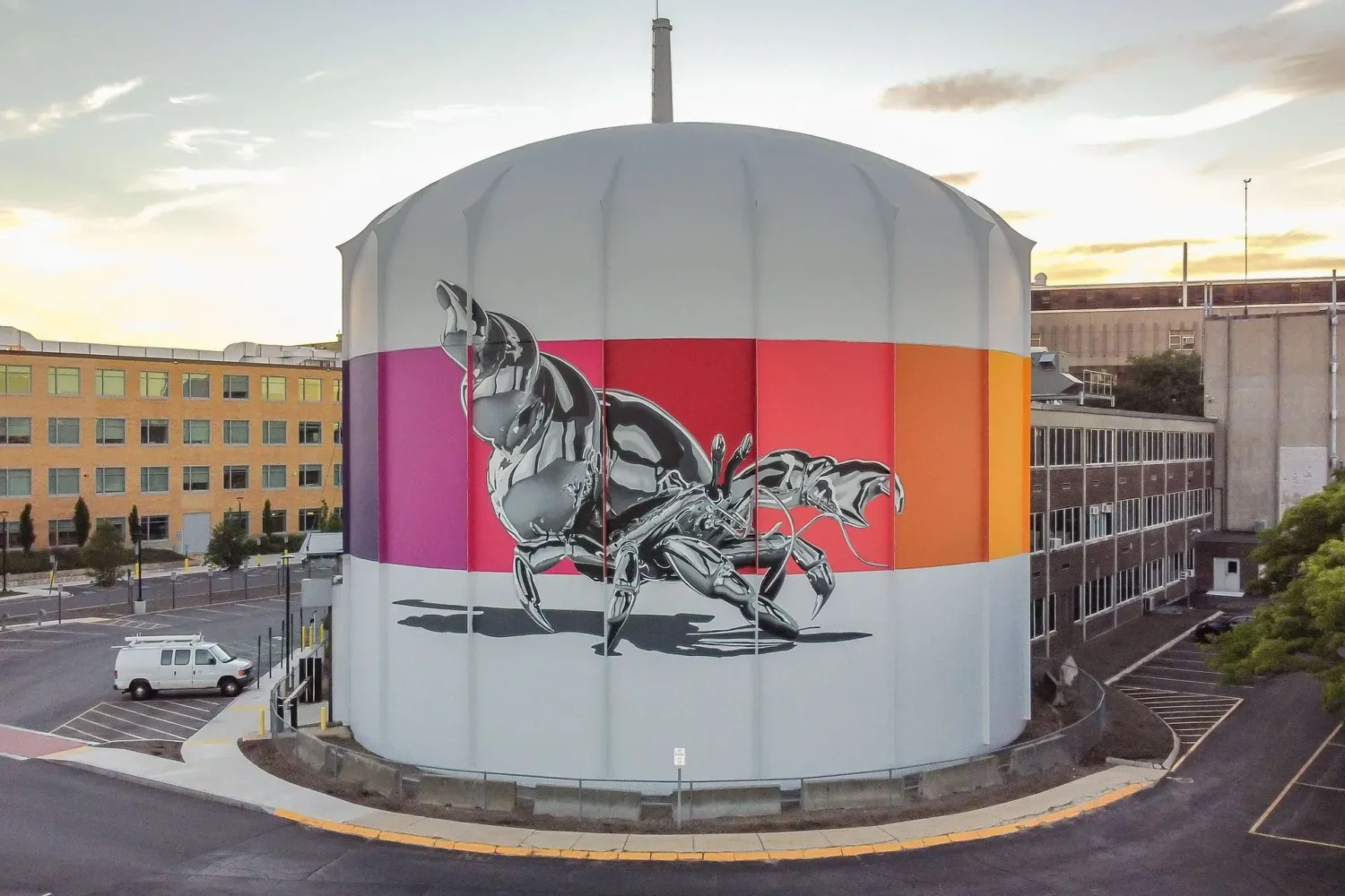 A bright mural of a surrealist creature on a water tower.