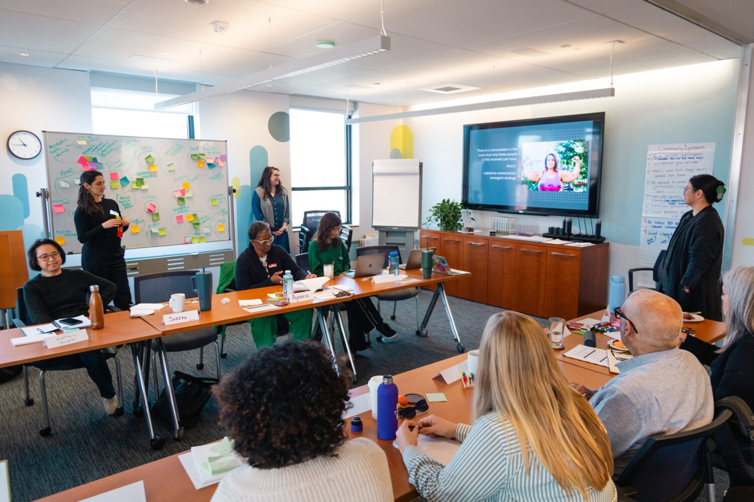 A group of grantees participates in a workshop in the North End conference room.