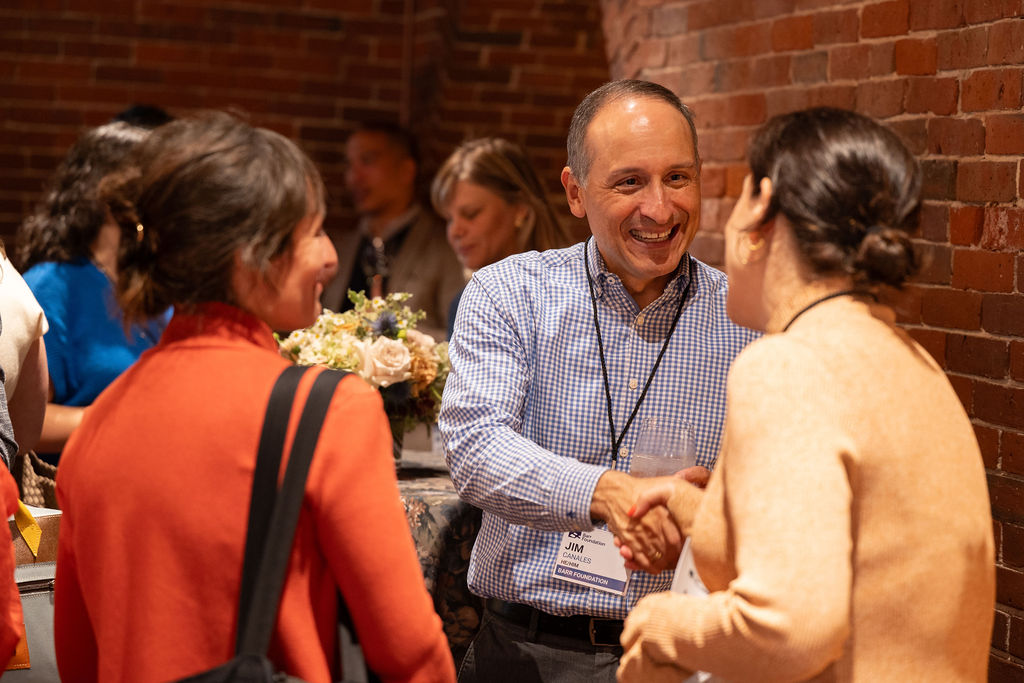 Jim Canales greets guests at an ArtsAmplified event.