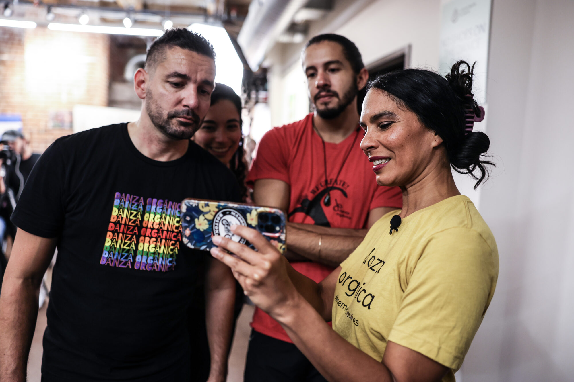 Dancers with Danza Organica review footage during a rehearsal.